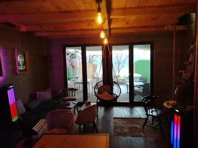 a living room with a couch and a table and chairs at Zmajevo Gnezdo II Water House in Beograd