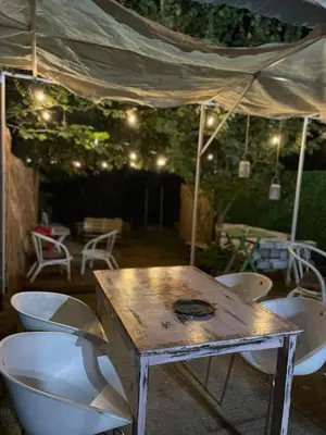 a table and chairs under a tent with lights at Zmajevo Gnezdo II Water House in Beograd