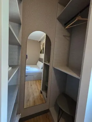 a small room with a mirror and a bed at Dukk in Belgrade