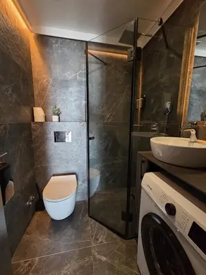 a bathroom with a shower and a toilet and a sink at Dukk in Belgrade