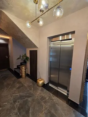 a lobby with a elevator and a potted plant at Dukk in Belgrade