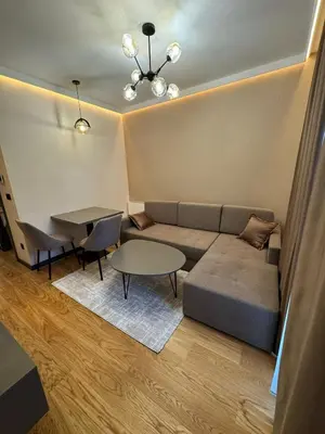 a living room with a couch and a table at Dukk in Belgrade