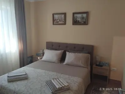 a bedroom with a bed with two towels on it at Prenoćište Lana 3 in Novi Banovci