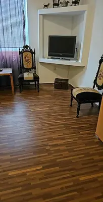 a living room with two chairs and a flat screen tv at Swiss Luxury Apartment in Beograd