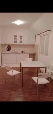 a room with a table and chairs and a kitchen at Swiss Luxury Apartment in Beograd
