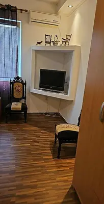 a living room with a flat screen tv on a wall at Swiss Luxury Apartment in Beograd
