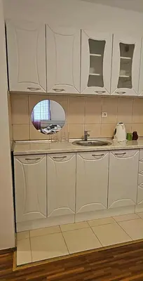 a kitchen with white cabinets and a sink at Swiss Luxury Apartment in Beograd
