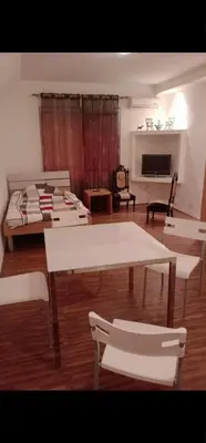 a living room with tables and chairs and a fireplace at Swiss Luxury Apartment in Beograd