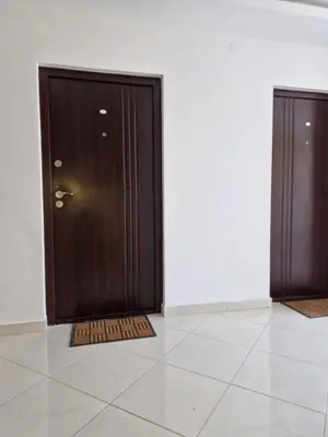two wooden doors in a room with a tile floor at Apartman New in Belgrade