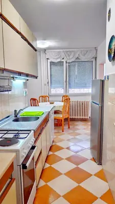 a kitchen with a refrigerator and a table at Home Sweet Home No1 in Belgrade