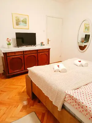 a bedroom with two beds and a flat screen tv at Home Sweet Home No1 in Belgrade