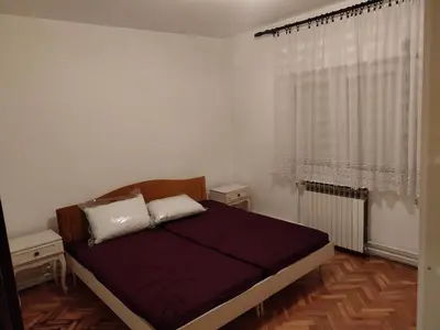 a bedroom with a bed and a window at Dve Breze