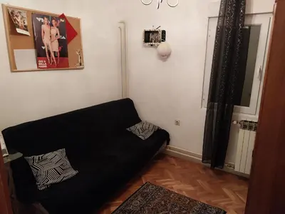 a living room with a black couch in a room at Dve Breze