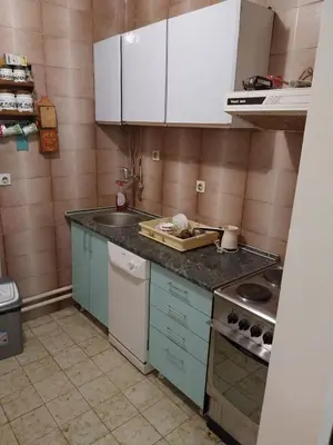 a kitchen with white cabinets and a counter top at Dve Breze