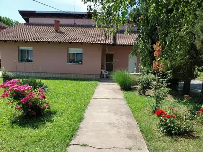a house with a walkway in front of a yard at Dve Breze