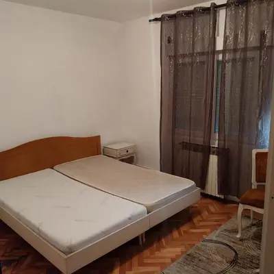 a small bedroom with a bed and a window at Dve Breze