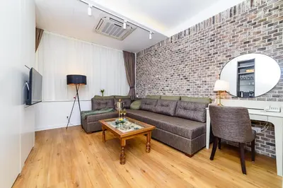a living room with a couch and a table at Belgrade Inn Garni Hotel in Belgrade