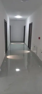 a empty room with four doors and a white floor at All SEASON in Beograd
