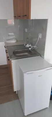 a kitchen counter with a sink and a faucet at All SEASON in Beograd