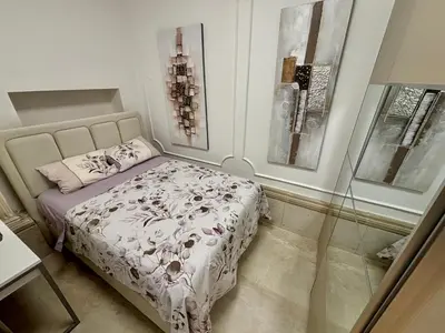 a bedroom with a bed and some pictures on the wall at ONYX Grand SPA Suite Zemun in Belgrade