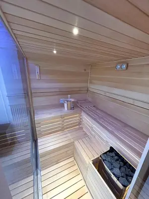 a wooden sauna with a bench in the middle at ONYX Grand SPA Suite Zemun in Belgrade