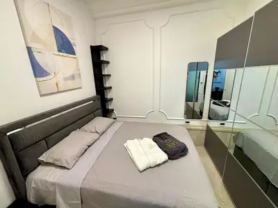 a bed in a room with a mirror at ONYX Grand SPA Suite Zemun in Belgrade