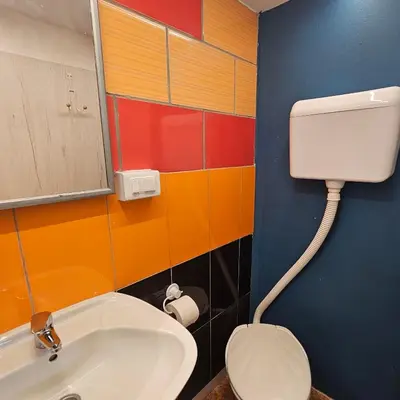 a bathroom with a toilet and a sink at Appartamento con ingresso privato e vista giardino in Belgrade