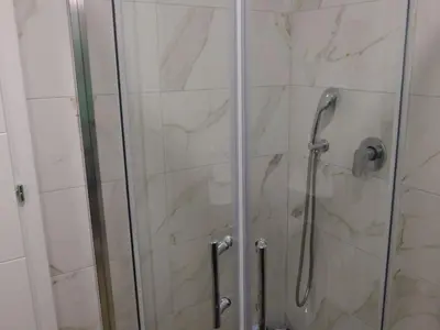 a bathroom with a shower with a glass door at Apartman ANDJA in Smederevo