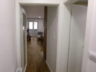 a hallway leading to a living room with a door open at Apartman ANDJA in Smederevo
