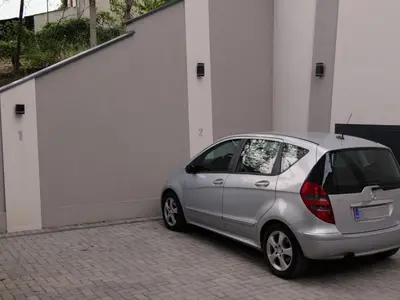 a small silver car parked next to a building at Apartman ANDJA in Smederevo