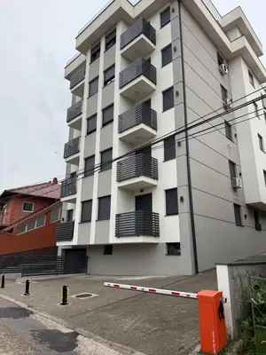 a large apartment building with balconies and a parking lot at Apartman ANDJA in Smederevo
