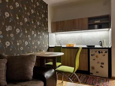a small kitchen with a table and a kitchen gmaxwell gmaxwell gmaxwell gmaxwell gmaxwell at Blok 63 in Beograd