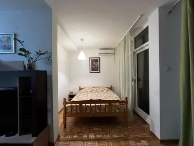 a small bedroom with a bed in a hallway at Blok 63 in Beograd