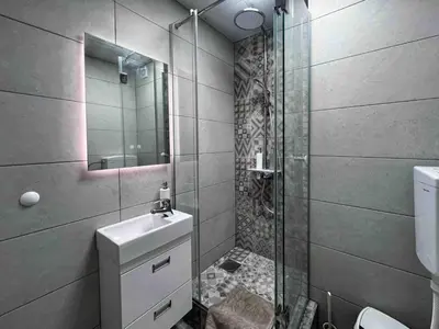 a bathroom with a shower and a toilet and a sink at Blok 63 in Beograd
