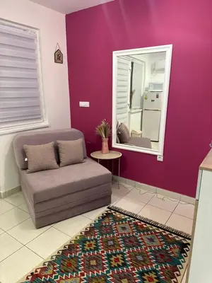 a purple living room with a couch and a mirror at Cozy studio in Belgrade in Belgrade