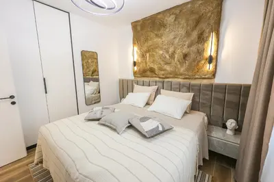 a bedroom with a bed with two pillows on it at Villa Cocosinella Belgrade in Surčin