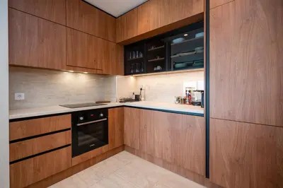 a kitchen with wooden cabinets and a stove at Star West Luxury in Belgrade