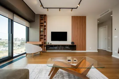 a living room with a glass coffee table and a television at Star West Luxury in Belgrade