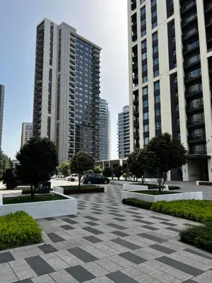a parking lot in a city with tall buildings at Beldorado Apartments - Belgrade Waterfront Azure Studio in Belgrade
