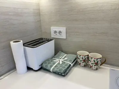 a kitchen with a stove and two mugs on a counter at Beldorado Apartments - Belgrade Waterfront Azure Studio in Belgrade