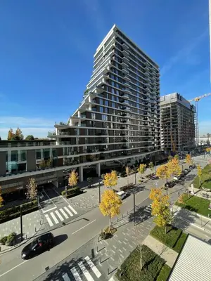 a tall building in a city with a parking lot at Beldorado Apartments - Belgrade Waterfront Azure Studio in Belgrade