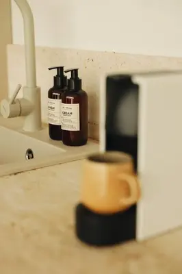 three bottles of soap sitting on a counter next to a sink at Like a therapy VILLA in Krčedin