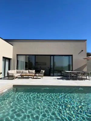 a swimming pool in front of a house at Like a therapy VILLA in Krčedin