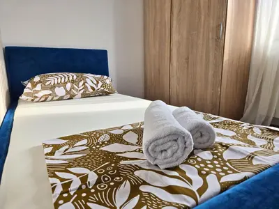 a bedroom with two towels on a bed at Airport 2BR Suite Filip in Beograd