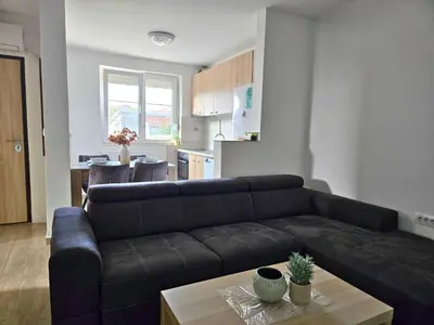 a living room with a couch and a table at Airport 2BR Suite Filip in Beograd