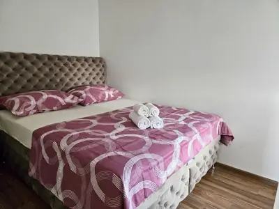 a bedroom with a bed with two stuffed animals on it at Airport 2BR Suite Filip in Beograd
