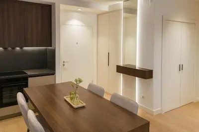 a kitchen with a wooden table and chairs at Belgrade Waterfront LuX Sky Residence in Belgrade