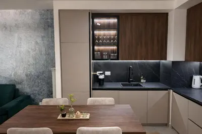 a kitchen with a wooden table and a sink at Belgrade Waterfront LuX Sky Residence in Belgrade