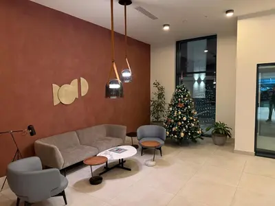a living room with a couch and a christmas tree at Belgrade Waterfront LuX Sky Residence in Belgrade