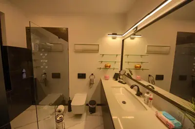 a bathroom with a sink and a shower and a mirror at House California